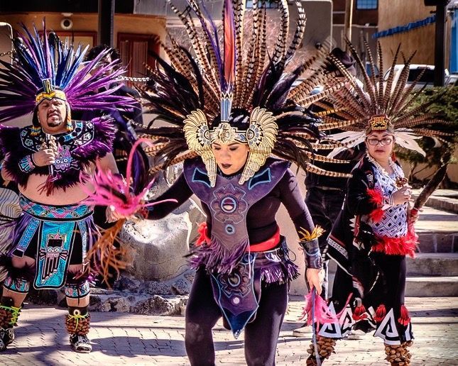 Native American dancers perform on the plaza in Taos, New Mexico.