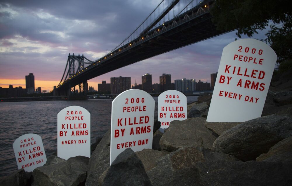 Fake tombstones placed by the Control Arms Coalition line New York's East River.