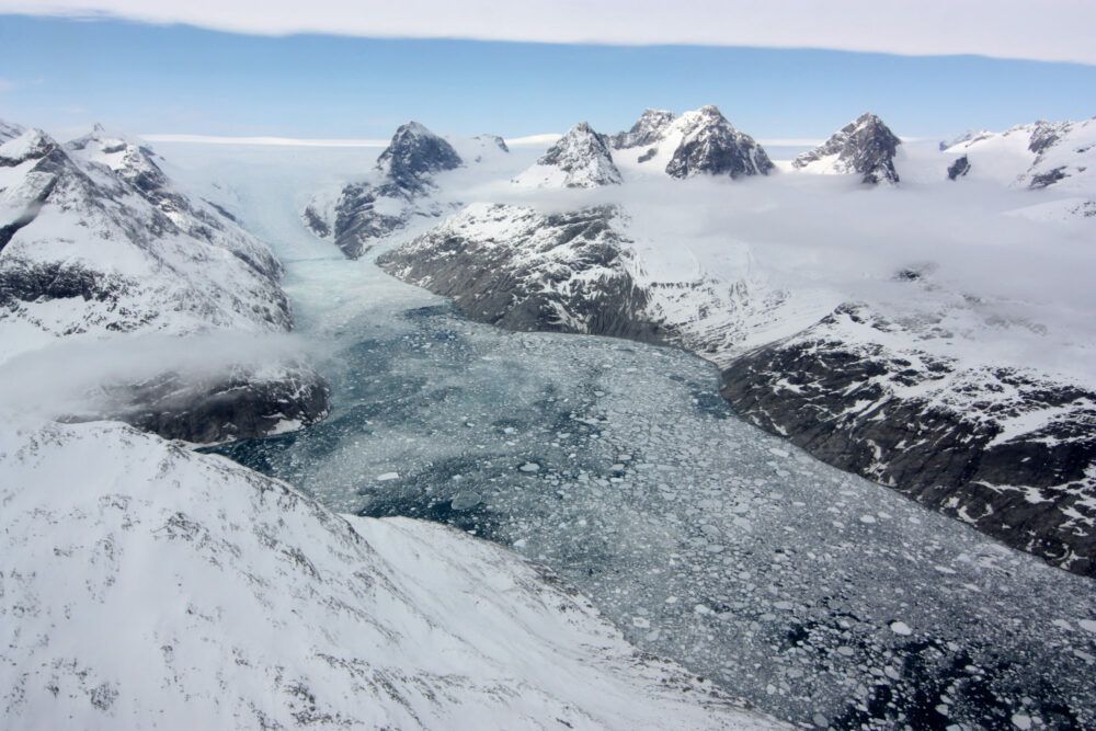 A glacier in eastern Greenland flowing through a fjord carved by the movement of ice.