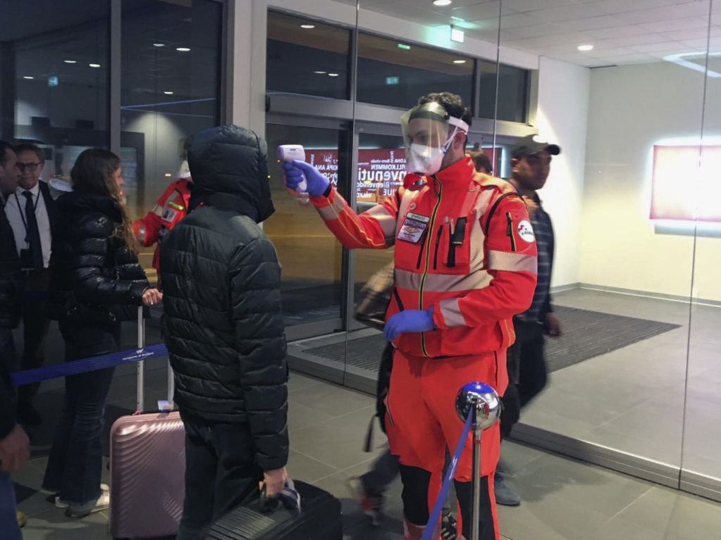 Civil protection volunteers conduct health checks at Bologna, Italy's international airport on February 6, 2020