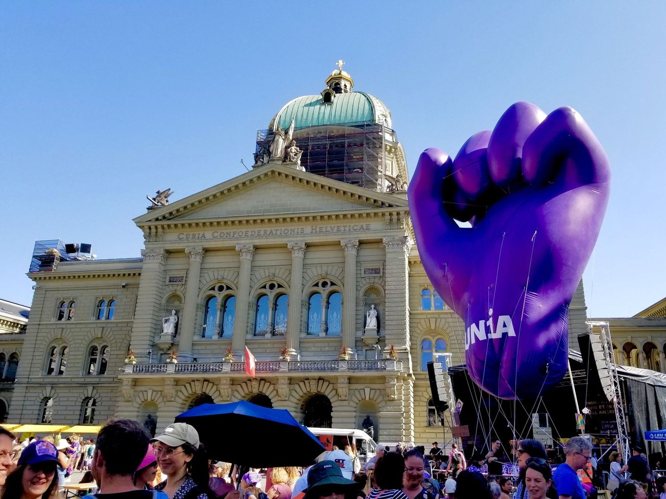 A trade union float appears beside the Swiss Parliament building Bern in June 2023