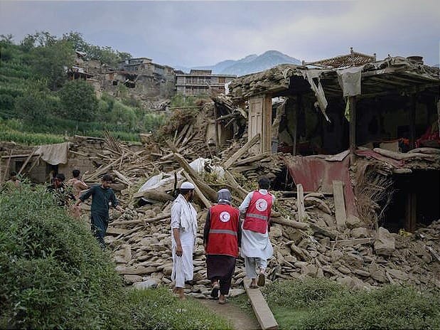 Afghan Red Crescent volunteers and local residents search for survivors and provide first aid.