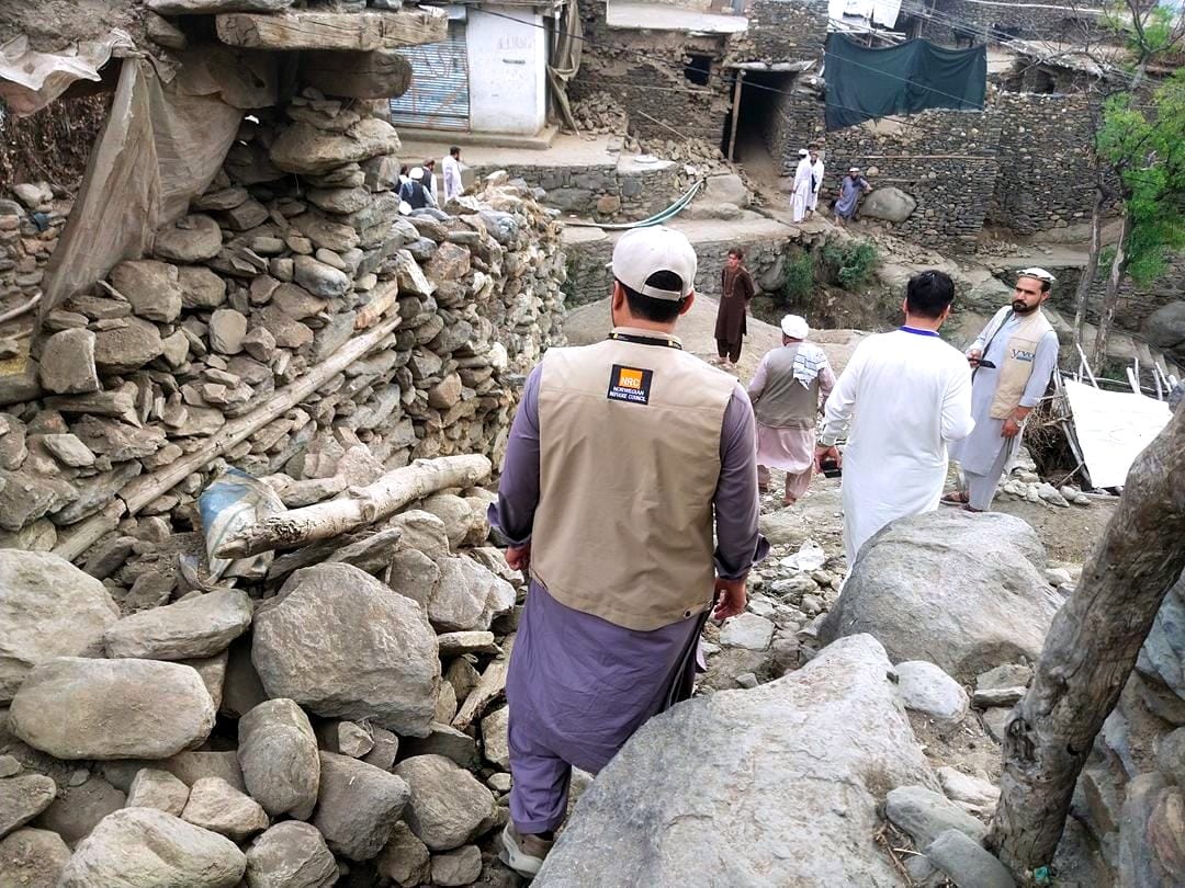 A Norwegian Refugee Council aid worker surveys the Afghan quake damage.