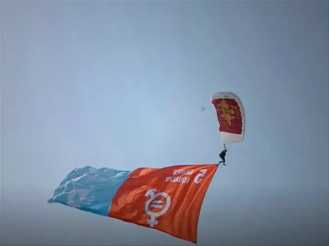 A team of parachutists above the Qatar National Convention Center carried brightly colored flags representing the U.N.'s 17 Sustainable Development Goals for 2030.