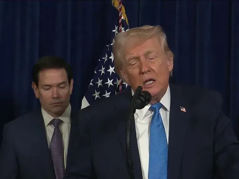 U.S. President Donald Trump, flanked by Secretary of State Marco Rubio, holds a press conference on the U.S. strike in Venezuela.
