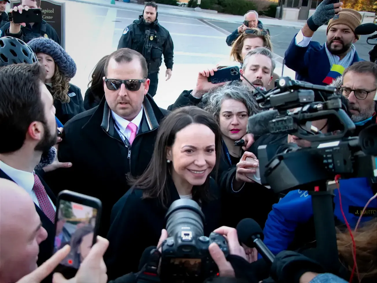 Venezuelan opposition leader María Corina Machado speaks with reporters after greeting supporters near the White House, where she met with U.S. President Donald Trump.